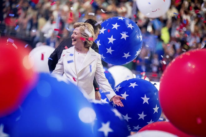 Democratic presidential candidate Hillary Clinton reacts to confetti and balloons as she stands on stage during the final day of the Democratic National Convention in Philadelphia. (AP Photo/Andrew Harnik)