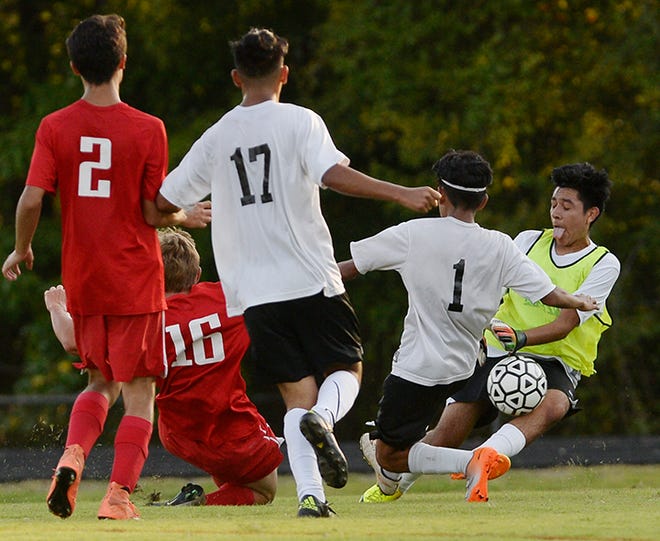 Graham's Kelvin Meija-Cruz, second from right, and goalkeeper Manny Sanchez attempt to fend off a shot by Southern Alamance's Fred McJunkin, second from left, during Wednesday night's game. Graham's Pedro Gonzalez, middle, and Southern Alamance's Ray Vera-Zapien, left, join the play. Southern Alamance won the boys' soccer game 3-2.
