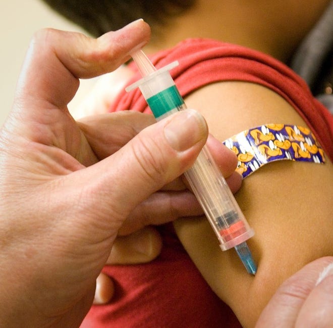(File) A child gets several vaccinations at the Bucks County Department of Health clinic in Quakertown in October 2011.