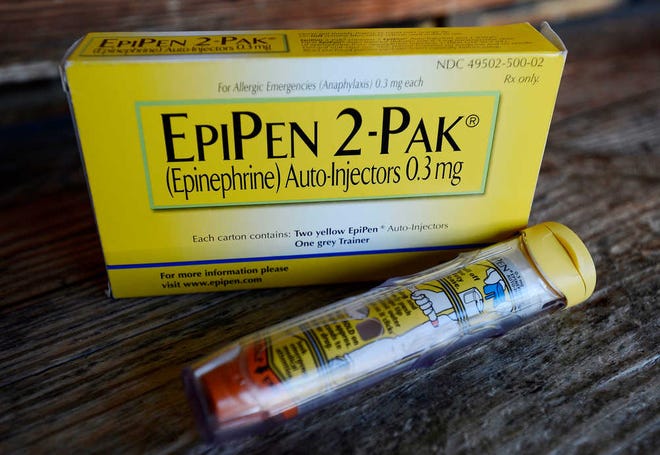 FILE - This Oct. 10, 2013, file photo, shows an EpiPen epinephrine auto-injector, a Mylan product, in Hendersonville, Texas. Mylan, now in the crosshairs over severe price hikes for its EpiPen, said Thursday, Aug. 25, 2016, it will expand programs that lower out-of-pocket costs by as much as half. (AP Photo/Mark Zaleski, File)