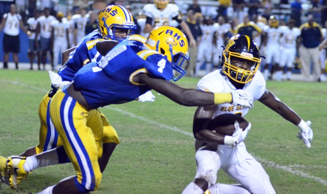 Winter Haven junior running back Terance Anglin runs the ball against Auburndale during the opening game of the season on Friday at Bruce Canova Stadium. BILL KEMP/THE LEDGER