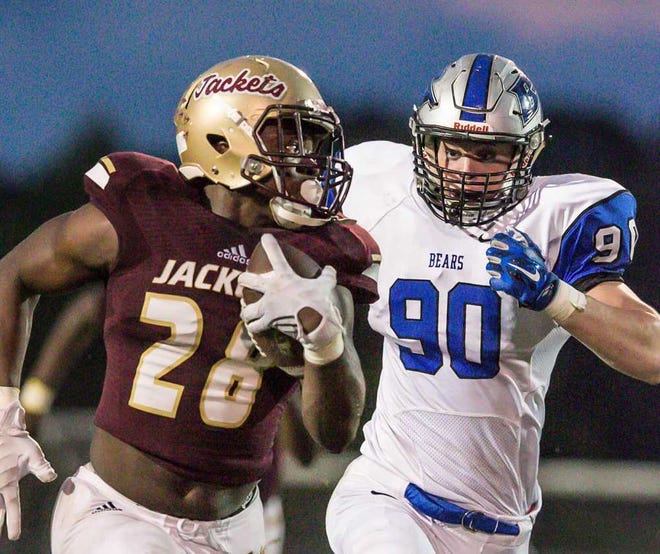 GARY MCCULLOUGH/CORRESPONDENT Bartram Trail's Parker Devine (90) closes in on St. Augustine running back Jahquise Russell on Sept. 25, 2015 at St. Augustine's Foots Brumley Stadium.