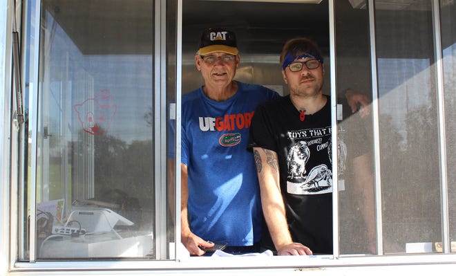 Chef Chris Patton, right, with his father and business partner, Jim Patton, are shown in their new Vanarchy Sandwiches food truck. (Submitted photo)