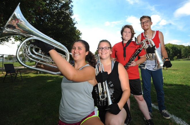TIMES-REPORTER PHOTO

Jenna Albaugh (left), Alyssa Ritter, Anna Brown and Andrew Huff prepare for the upcoming New Philadelphia Band Show Preview sponsored by the New Philadelphia Marching Quakers and the Band Boosters.