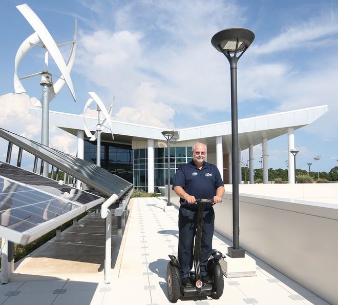 Gulf Coast State College President Dr. John Holdnak rides a Segway on Monday at Gulf Coast State College. Holdnak urges faculty and staff to go the extra mile through volunteer work, saying, “We’re not separate from this community; we’re a part of this community.”