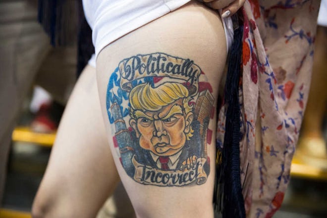 FILE/Associated Press Jennifer Pitta shows off a tattoo of presidential candidate Donald Trump during a campaign rally. This photo will be included in the International Center of Photography's show in Long Island, N.Y.