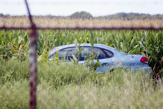 A car driven by a burglary suspect sits in a cornfield Friday on the Iowa Army Ammunition Plant grounds following a high speed chase along Washington Road in West Burlington.