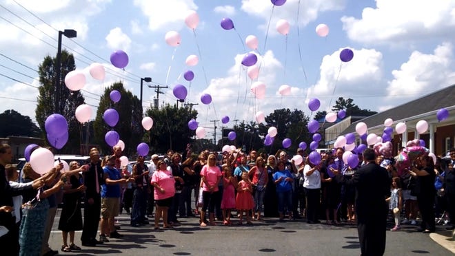 Family and friends release pink and purple balloons in memory of 3-year-old Jordyn Dumont at Greene Funeral Service on South York Road in Gastonia at her funeral service Saturday. ERIC WILDSTEIN/THE GAZETTE