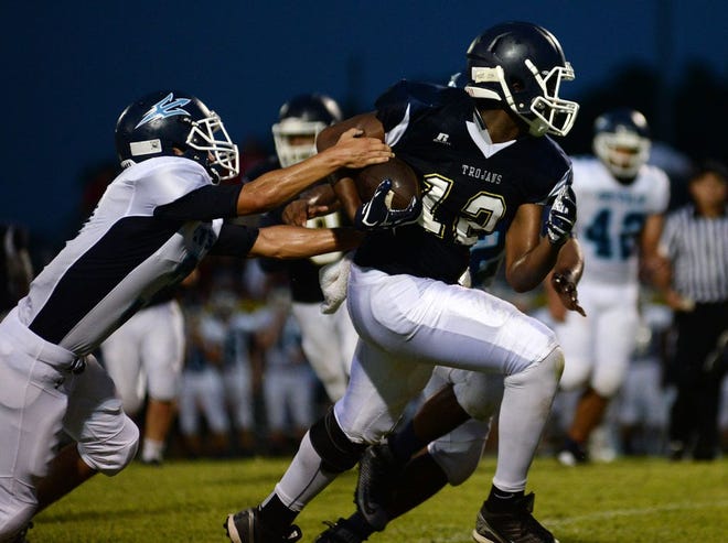 Jones Senior's Rasheed Cox (12) escapes the grasp of South Lenoir defenders in Friday's home game.