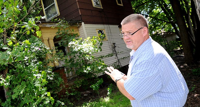 J.R. Rinaldi has the task of tracking down, examining and recording homes in the city of Canton that could be demolished as part of the Neighborhood Initiative Program. (CantonRep.com / Ray Stewart)