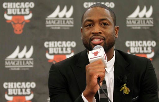 FILE- In this July 29, 2016, file photo, Chicago Bulls player Dwyane Wade speaks during a news conference in Chicago. A family spokesman says a cousin of Wade's was fatally shot Friday, Aug. 25, while pushing a baby in a stroller on the city's South Side. Wade posted on Twitter: "My cousin was killed today in Chicago. Another act of senseless gun violence. 4 kids lost their mom for NO REASON. Unreal." (AP Photo/Tae-Gyun Kim, File)