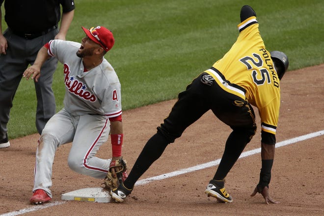 (File) Phillies third baseman Andres Blanco reacts after being spiked on the glove hand while making the tag on the Pirates' Gregory Polanco in the fifth inning Sunday, July 24, 2016.