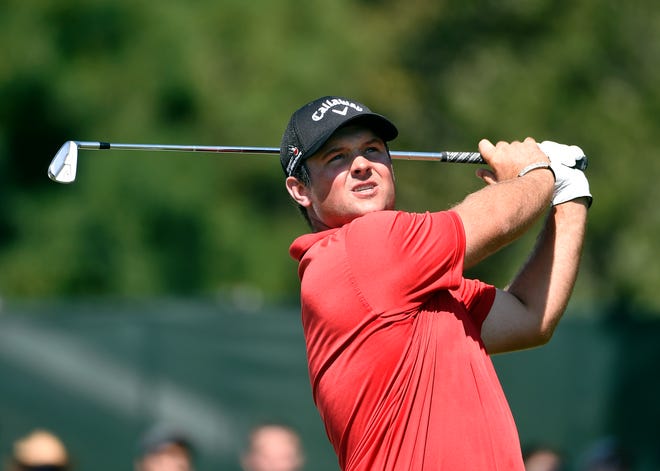Patrick Reed watches his tees hot from the third hole during the final round of The Barclays golf tournament in Farmingdale, N.Y., Sunday, Aug. 28, 2016.