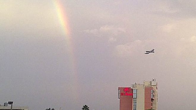 A plane takes off from Palm Beach International Airport as a rainbow appears Sunday Aug. 30, 2015 in West Palm Beach. (IPhone photo) (Bill Ingram / Palm Beach Post)