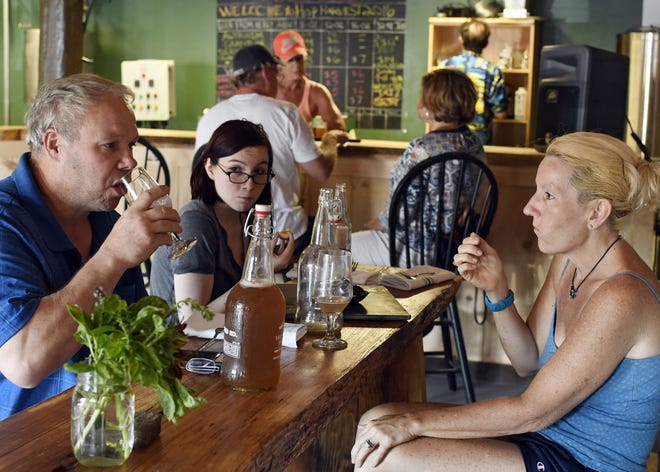 Scott and Lynne Crafts of Monson with their daughter, Alexis, 14, sample beverages and snacks at Homefield Brewery, on Wednesday. T&G Staff/Christine Hochkeppel