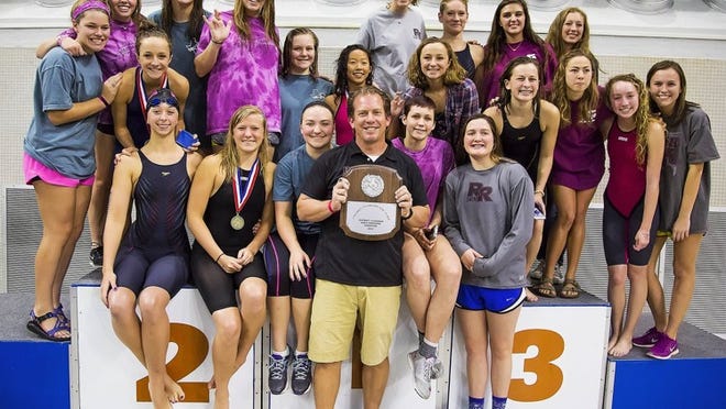 Coach Thomas Arredondo and the Round Rock girls swim team show off their first-place hardware after last weekend’s district swim meet. PHOTO BY JOHN GUTIERREZ FOR ROUND ROCK LEADET