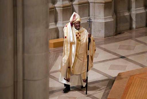 In this Sunday, Nov. 1, 2015, file photo, Episcopal Church Presiding Bishop Michael Curry waves to the crowd after Mass at the Washington National Cathedral in Washington. Curry, the church's first black leader, was elected in June 2015 to succeed Presiding Bishop Katharine Jefferts Schori, the first woman leader of the church. (AP Photo/Jose Luis Magana)