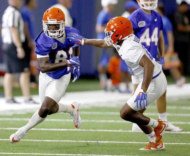 Florida wide receiver Antonio Callaway runs a route against defensive back McArthur Burnett during practice on Aug. 5.