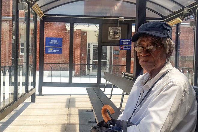 Edith Stowe, a resident of Washington, D.C., waits for her bus at the MedStar Washington Hospital Center in the District of Columbia in July 2016. Stowe lives about 5 miles away from the hospital and relies on the city buses to get to her appointments at least twice every three months.