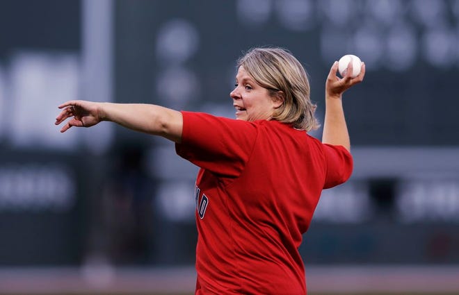 Cancer survivor Jodi Killeffer, of Braintree, Mass., delivers the ceremonial first pitch before the first inning of a baseball game at Fenway Park, Monday, Aug. 29, 2016, in Boston. (AP Photo/Charles Krupa)