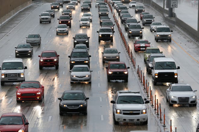 Drivers make their way in the rain along Interstate 95 on Tuesday in Miami. Forecasters at the National Hurricane Center in Miami said a tropical depression in the Gulf of Mexico could hit northern Florida as a tropical storm later in the week and possibly head toward the Atlantic coast.