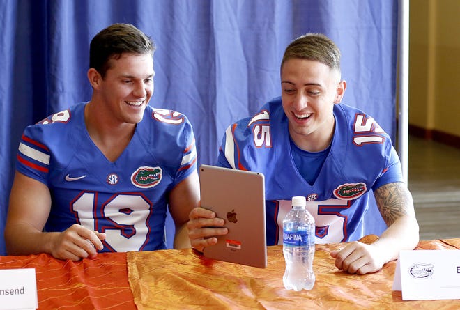 Florida punter Johnny Townsend, left, and kicker Eddy Pineiro laugh while recording a Twitter live question during media day Aug. 3. (Matt Stamey/The Gainesville Sun)
