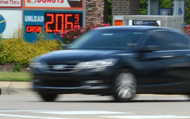A vehicle passes by the Jam Mart, 7403 Phoenix Ave., as the price of fuel shows $2.06 on Monday, August 29, 2016. BRIAN D. SANDERFORD/TIMES RECORD