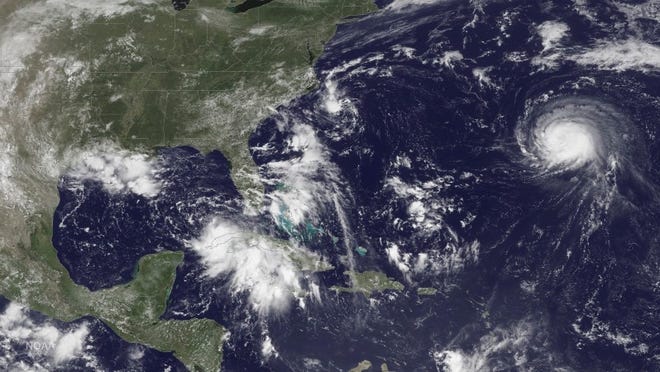 Three storm systems are shown (L TO R) Tropical Depression Nine to the southeast of Florida, Tropical Depression Eight just off the coast of the Carolinas and Hurricane Gaston in the central Atlantic Ocean are shown in this GOES East satellite image captured August 29, 2016. NOAA/handout via REUTERS