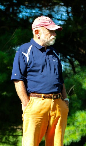 Hillsdale Academy coach Charlie Blood observes his golfers in action. ANDREW KING PHOTO