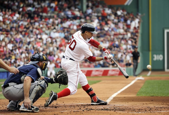 Mookie Betts hits a double in front of Rays catcher Bobby Wilson in the first inning of the Red Sox win at Fenway Park Wednesday afternoon.