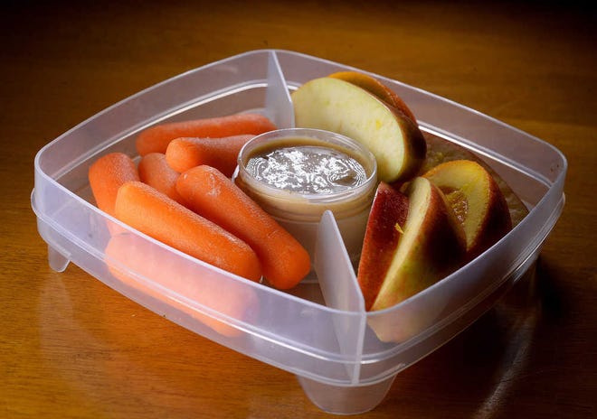 Salted Tahini Spread is an easy dip with carrots and apple slices. Oranges will keep the apples from turning brown too fast. (Diedra Laird/Charlotte Observer/TNS)