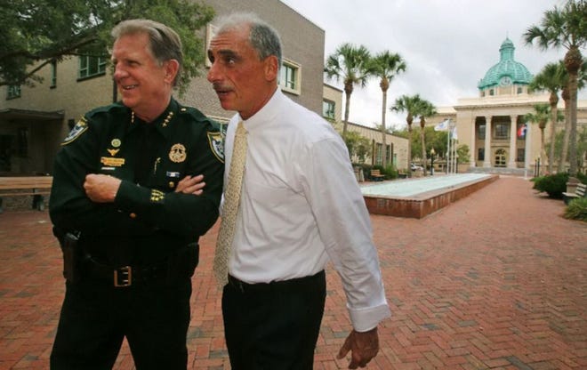 Volusia County Sheriff elect Mike Chitwood and Volusia County Sheriff Ben Johnson talk about the transition outside the County Building in DeLand, Wednesday, Aug. 31, 2016. News-Journal/NIGEL COOK