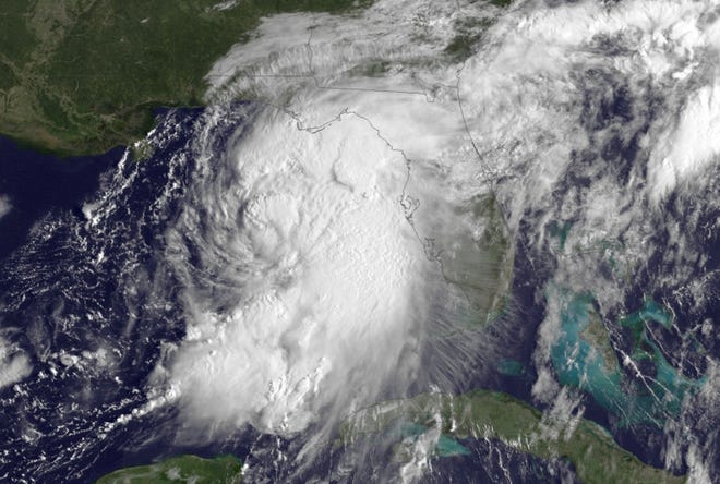 Hurricane Hermine (pictured in this satellite image while still a tropical storm) bears down on Florida Gulf Coast Thursday. Hermine's track could bring it close enough for wind and rain on Monday in SouthCoast.

NOAA image via AP