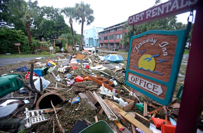 A street is blocked from debris washed up from the tidal surge of Hurricane Hermine Friday, Sept. 2, 2016, in Cedar Key, Fla. Hermine was downgraded to a tropical storm after it made landfall. (AP Photo/John Raoux)
