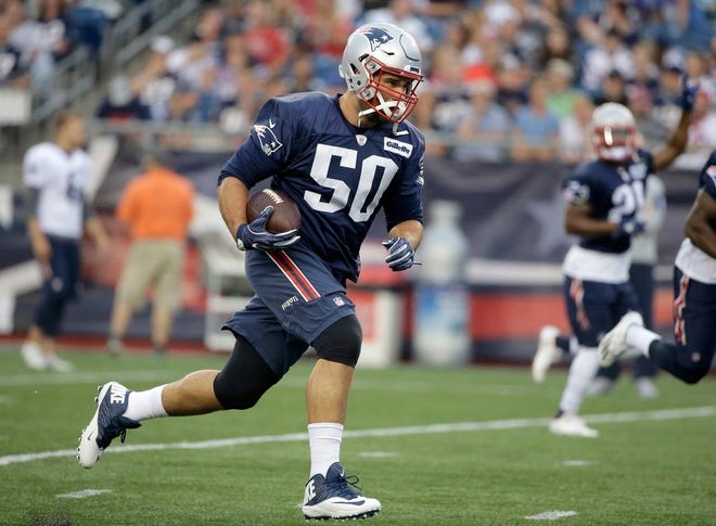 FILE - In this Monday, Aug. 1, 2016, file photo, New England Patriots defensive end Rob Ninkovich runs with the ball during NFL football training camp in Foxborough, Mass. The league announced Friday, Sept. 2, 2016, that Ninkovich has been suspended for the first four games of the regular season for violating the NFL's policy on performance enhancing substances.