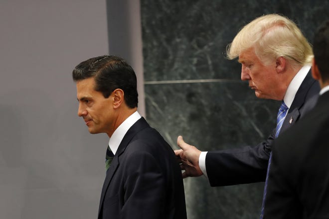 Republican presidential nominee Donald Trump walks with Mexico President Enrique Pena Nieto at the end of their joint statement at Los Pinos, the presidential official residence, in Mexico City, Wednesday, Aug. 31, 2016. Trump is calling his surprise visit to Mexico City Wednesday a 'great honor.' The Republican presidential nominee said after meeting with Peña Nieto that the pair had a substantive, direct and constructive exchange of ideas.(AP Photo/Dario Lopez-Mills)