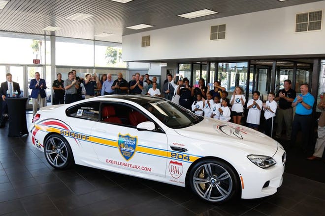 The Police Athletic League unveiled the pace car for the Excellerate event at Tom Bush BMW.
