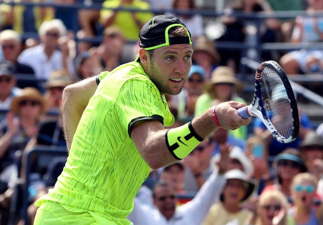 Jack Sock, of the United States, returns a volley at the net during a match against Marin Cilic, of Croatia on Friday in New York. Sock won the match. (AP Photo/Seth Wenig)