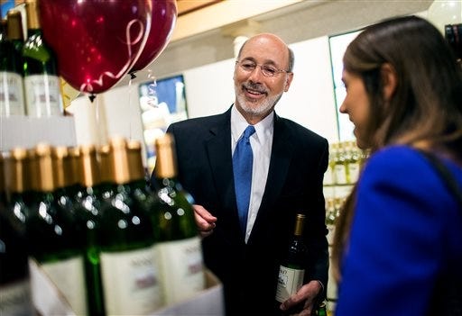 Pennsylvania Gov. Tom Wolf purchases wine and beer after a press conference to introduce the sale of wine at Wegmans, Thursday, Sept. 1, 2016, in Mechanicsburg, Pa. Wegmans is the first supermarket in central Pennsylvania to sell wine under the provisions of†Act 39, which was signed in June and opens up alcohol sales in the state.† (Sean Simmers/PennLive.com via AP)