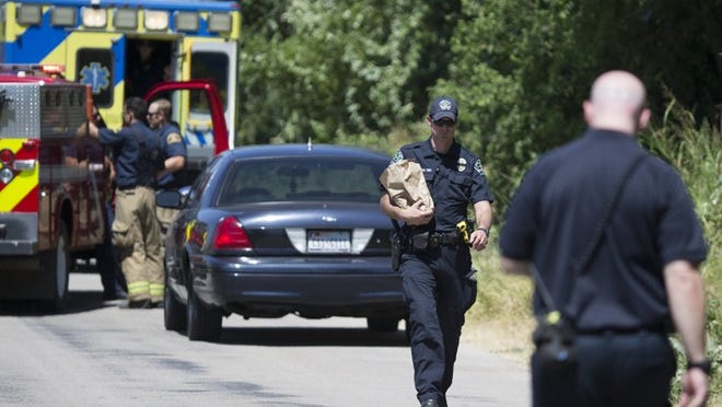 Emergency personnel found Thursday morning the body of a man in his 30s on Fallwell Lane, near the airport. RICARDO B. BRAZZIELL/AMERICAN-STATESMAN