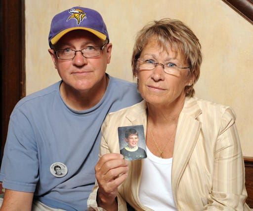 In this Aug. 28, 2009, file photo, Patty and Jerry Wetterling show a photo of their son Jacob Wetterling, who was abducted in October of 1989 in St. Joseph, Minn.