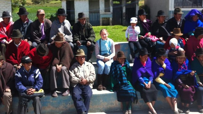 Lilly sits with patients and families outside a mountain village clinic near Riobamba, Ecuador.
