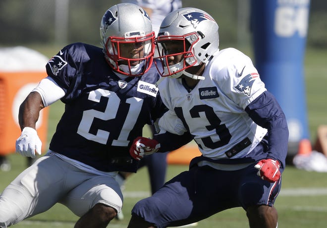 New England Patriots cornerback Malcolm Butler (21) and wide receiver DeAndre Carter perform field drills during training camp last month. AP Photo