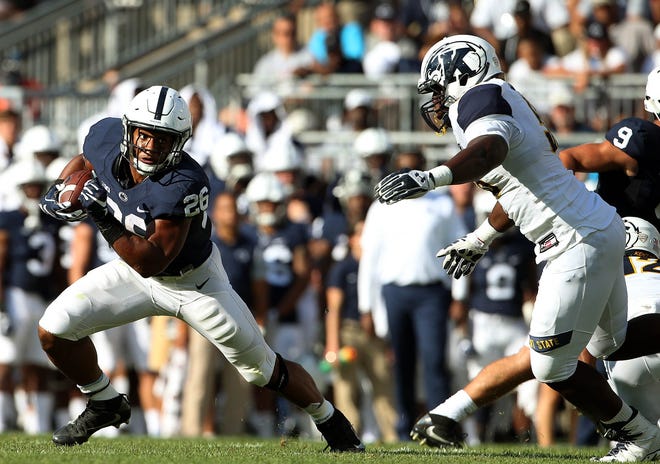 Penn State's Saquon Barkley (26) gets to the outside against Kent State during the first half of an NCAA college football game in State College, Pa., Saturday, Sept. 3, 2016, (AP Photo/Chris Knight)