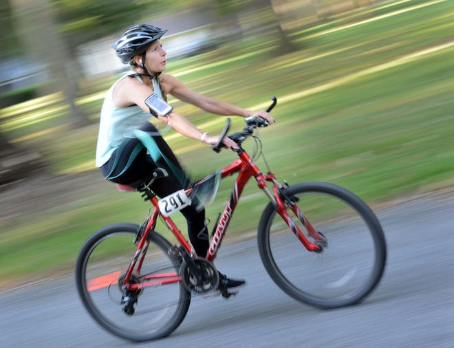 Jesse Swanson hops off her bike in transition while competing in the Bucks County Duathlon on Sunday, Sept. 4, 2016, at Washington Crossing Park in Washington Crossing.