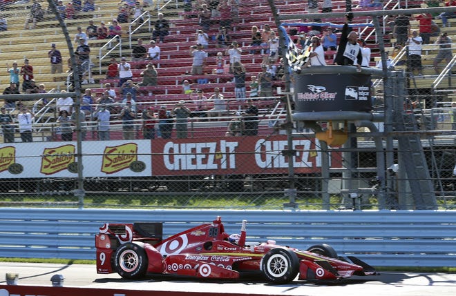 Scott Dixon of New Zealan, pumps his fist as he takes the checkered flag to win the IndyCar Grand Prix at The Glen auto race Sunday in Watkins Glen, N.Y. Associated Press/Mel Evans
