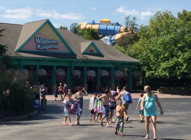 Patrons walk into Wildwater Kingdom for the last time on Monday. Owner Cedar Fair said it would not be re-opening next year.  (Betty Lin-Fisher/Akron Beacon Journal)