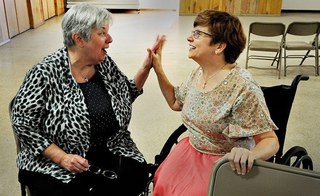 Anne Mauro (left), organizer of the Handicapped Crusaders, a group of special needs individuals, interacts with longtime member Lori McFarland, of Bristol Township, on Tuesday, Aug. 23, 2016, at the Faith Reformed Church in Bristol Township. The social club will be celebrating its 50th anniversary on Sept. 10.
