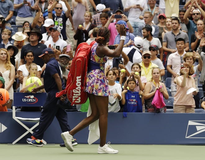 Venus Williams waves to the crowd as she walks off the court after losing to Karolina Pliskova on Monday in the fourth round of the U.S. Open.