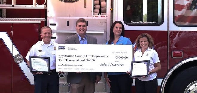 From left, Deputy Chief Banta, Marion County Fire Rescue; Jamie Dingle, Safeco Territory Manager; Trina Bowden, AAA Field Insurance and Membership Manager/AAA Roadwise Driving Safety Instructor; and Dianne McDonald, AAA Field Manager; participated in the recent donation event. Submitted photo.
